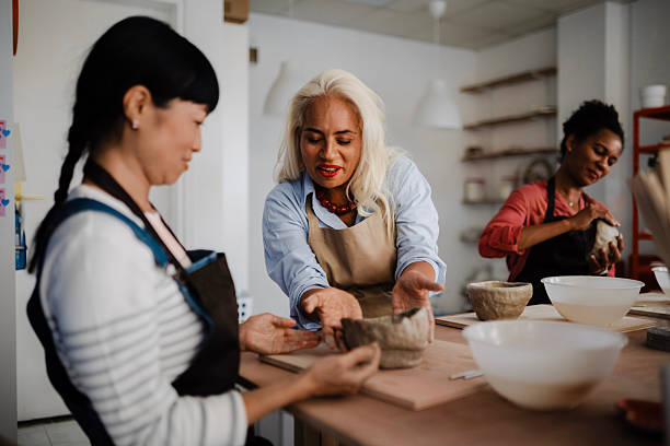 istock Multicultural Group of Three Women Decorating Pottery in Workshop 2235798534
