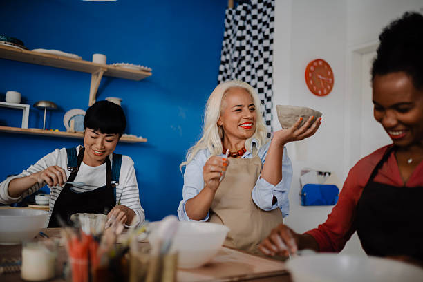 istock Multicultural Group of Three Women Decorating Pottery in Workshop 2235799223