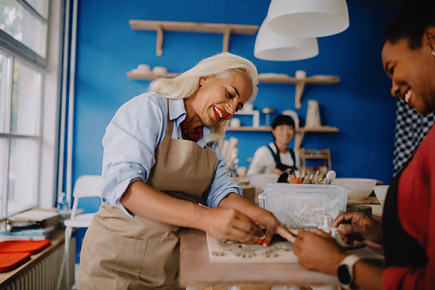 istock Multicultural Group of Three Women Decorating Pottery in Workshop 2235799463