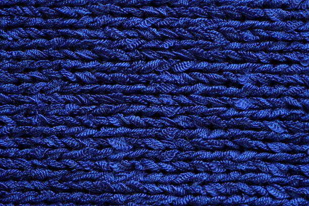 Blue synthetic fiber texture. Braided threads fabric texture. Extreme close up