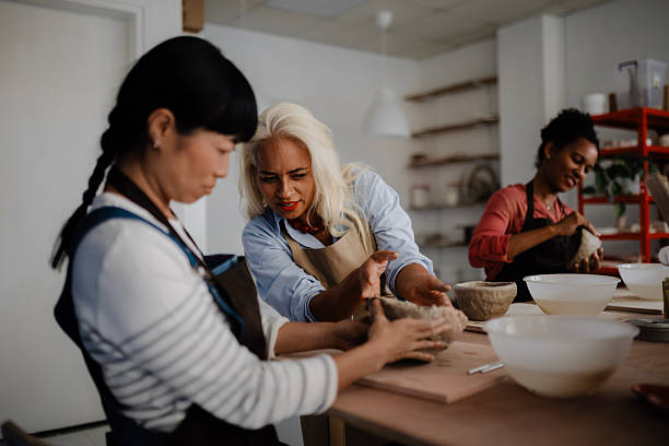 istock Two women decorating ceramic pieces they handcrafted in a pottery studio. 2235804733