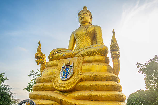 istock Golden Buddha statue in meditation pose with decorative base and naga details under clear sky during sunset in Big Buddha temple on Phuket island, Thailand. Buddhism in Thailand 2235805210