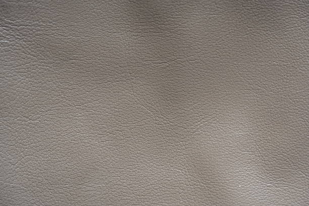 istock beige leather texture close-up, seams on leather jacket as background, beige natural leather as background, light brown leather stitching 2235805277