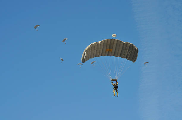 istock Parachute drop of uniformed soldiers 2235805577