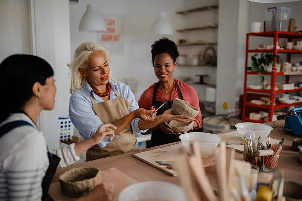 istock Multicultural Group of Three Women Decorating Pottery in Workshop 2235805706