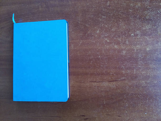 istock Blue notebook on wooden background. Top view. Copy space for text 2235807671