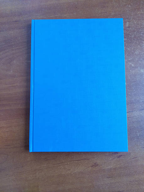 istock Blank blue book on wooden background 2235807677