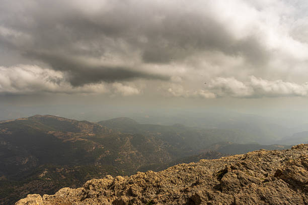 Dark clouds forming over the mountainous landscape of penyagolosa natural park in castellón, spain, create a dramatic and moody atmosphere, hinting at an approaching storm