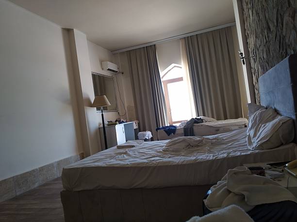 istock Interior of a hotel room with a double bed and a bedside table 2235808136