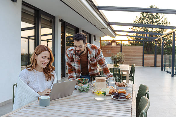 istock Couple working and dining on outdoor terrace during a relaxing afternoon 2235813202
