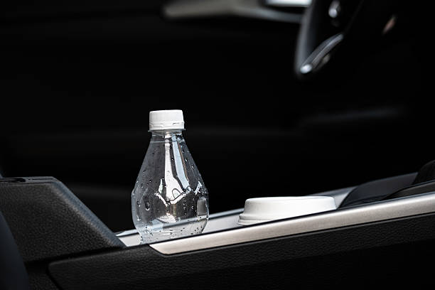 istock Coffee cup and plastic bottle in car cup holder – modern travel habits and single-use awareness 2235813254