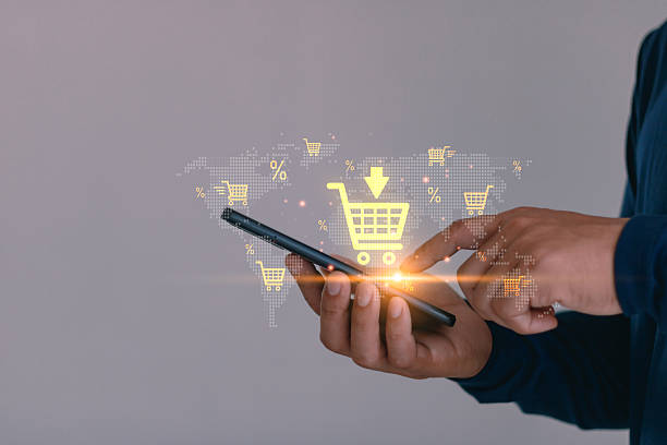 istock Online shopping concept with man using smartphone and digital cart icon on virtual world map, illustrating e-commerce, mobile retail, global marketplace, internet business and digital marketing. 2235814628