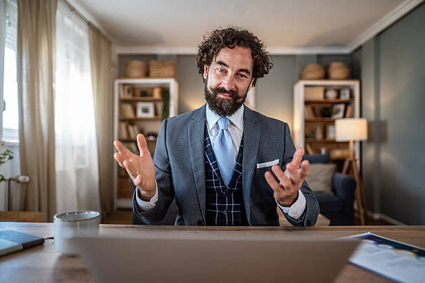 istock Elegant businessman having a video call from his home office 2235814864