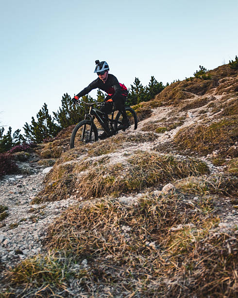 istock Female mountain biker descends steep mountain slope 2235819373
