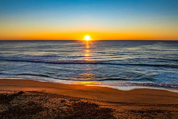 istock Sunrise at the seaside with a cloudless sky 2235819561
