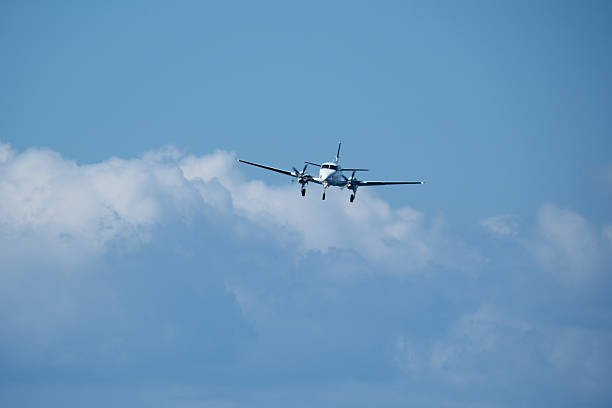 istock A propeller plane approaches the runway against a backdrop of clouds. 2235824949