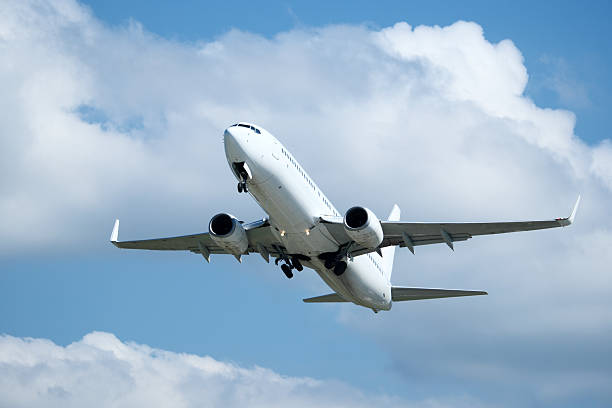 istock White plane climbing higher against the clouds. Airplane flying in the blue sky, take-off from airport 2235825043