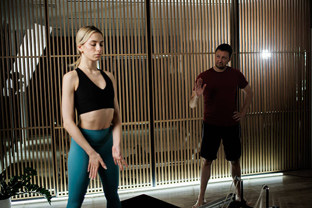 istock Yoga instructor guiding a woman through a mindfulness exercise in a serene studio environment during a calm afternoon 2235826945