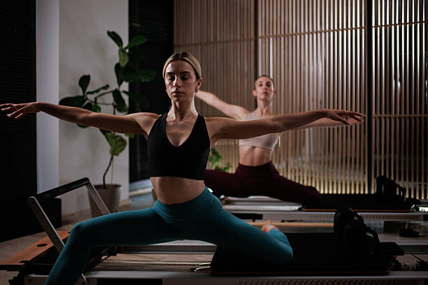 istock Women practicing pilates in a bright studio with wooden accents during a morning class focused on flexibility and strength 2235826985