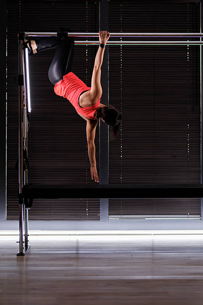 istock Fitness enthusiast engages in a challenging workout routine on a reformer machine in a modern studio during a bright morning session 2235827169