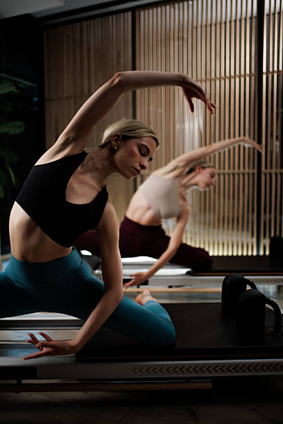 istock Yoga practice session in a serene studio with two practitioners focusing on balance and flexibility during evening hours 2235827333