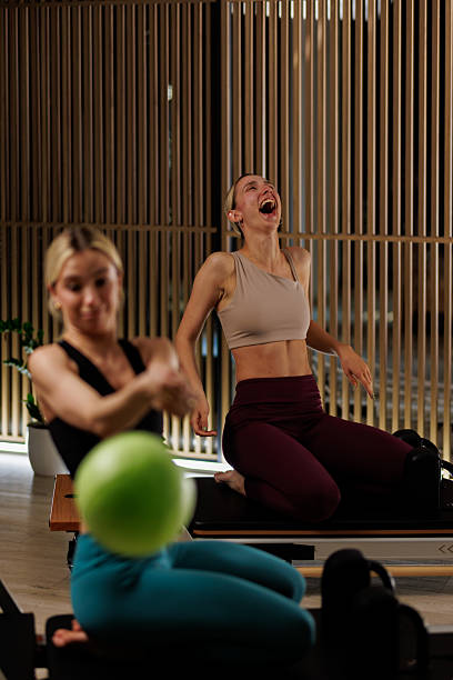 istock Joyful moments during a pilates class with laughter and fitness in a modern studio setting providing an energetic atmosphere 2235827379