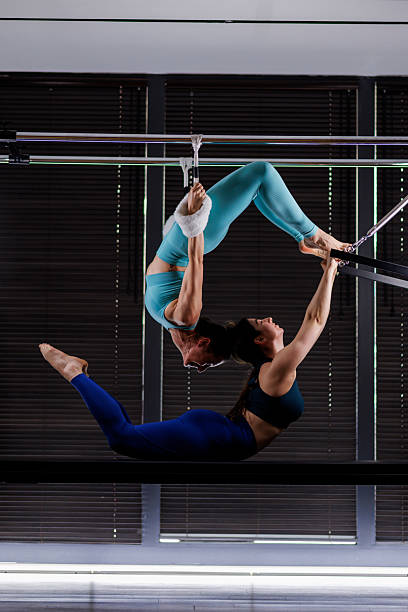 istock Two acrobats performing a stunning aerial act on silks in a modern studio during daylight hours 2235827430