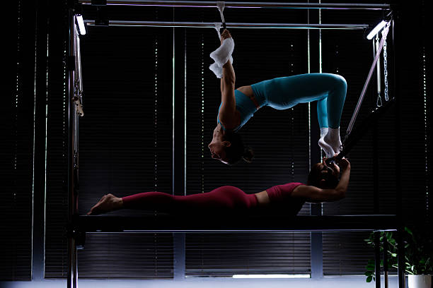 istock Two performers demonstrate aerial acrobatics in a dimly lit studio showcasing strength and flexibility during a training session 2235827545