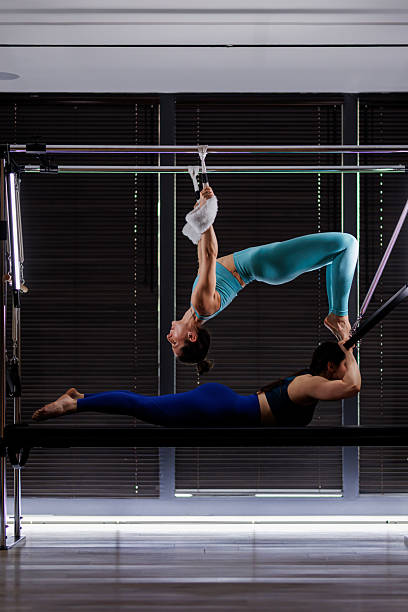 istock Two women perform a dynamic acrobatic routine in a modern studio during a fitness class focused on strength and flexibility training 2235827678