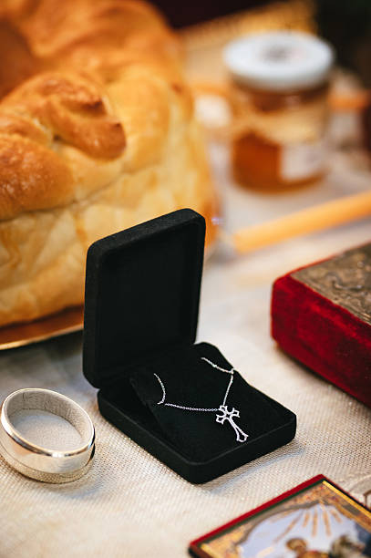 Gold cross pendant in box for a baptism.