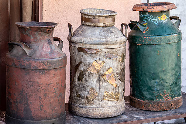 istock Three old metal milk cans sit on a table 2235828631