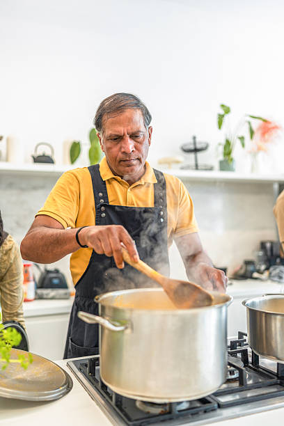 istock Expert Indian Chef Preparing Traditional Cuisine in Kitchen 2235829584