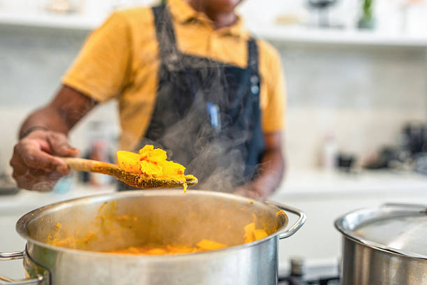istock Mature Indian Chef Prepares Dish in Modern Kitchen 2235829585