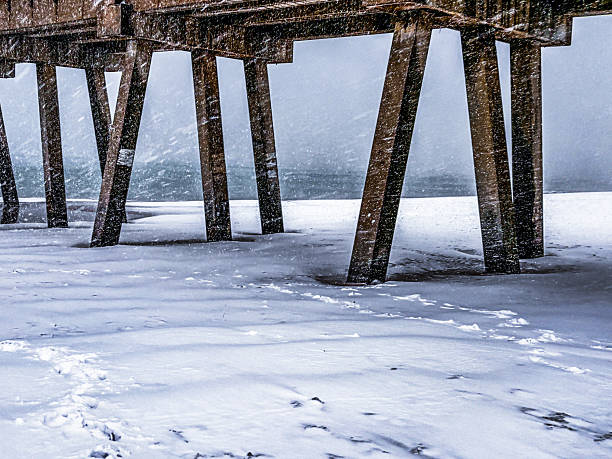 istock Serene Pier on a Snow-Covered Beach in Winter: Blizzard on Navarre Beach, Florida 2235829588
