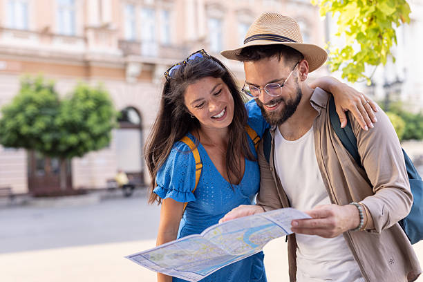istock Smiling couple with map planning their next city exploration 2235829626