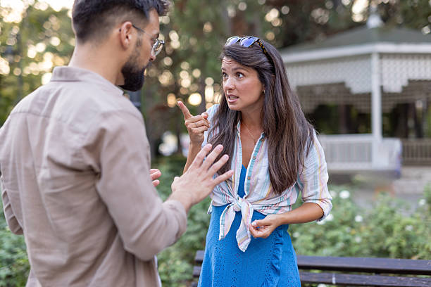 istock Woman points passionately as man raises hands in conversation. 2235829631