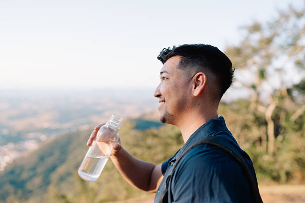 istock Man drinking water outdoors 2235832053