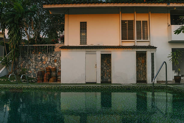 istock Modern Tropical House Exterior with Swimming Pool at Sunset 2235834424