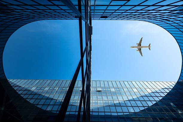 istock Modern building glass facade with airplane in clear sky 2235841282
