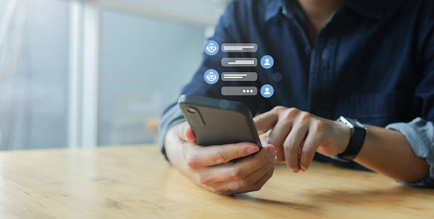 istock close up young man hold smartphone and use service on website to talk and ask question and consult about business with Ai model assistant chat for chatbot future technology and lifestyle concept 2235841692