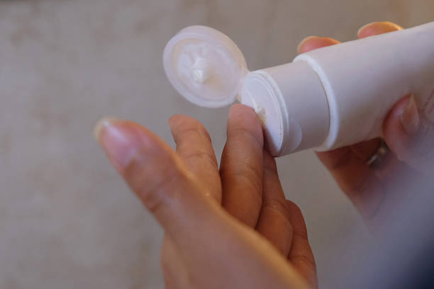 istock Unrecognizable Person Squeezing Facial Cleanser onto Hand 2235844847
