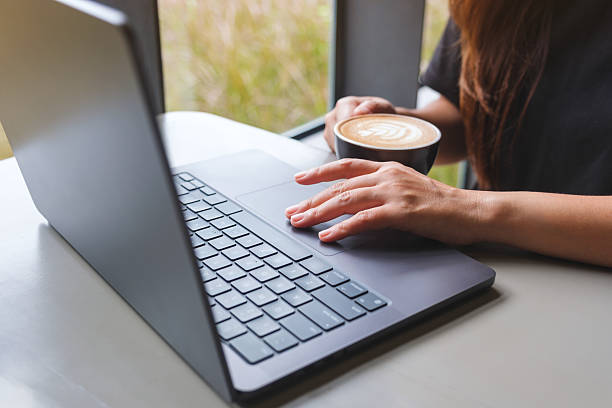 istock Closeup image of a woman working and touching on laptop computer touchpad 2235847419