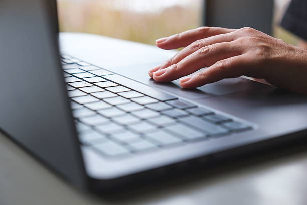 istock Closeup image of a woman working and touching on laptop computer touchpad 2235847422