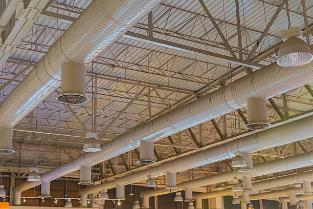 istock Air conditioning ducts on the ceiling of a large building hall 2235851499
