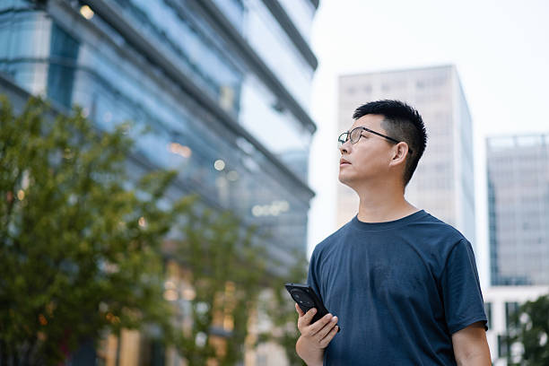 istock asian man using smart phone in urban 2235855295