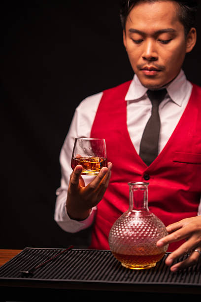 istock Bartender is pouring whiskey into a glass in a restaurant 2235858019