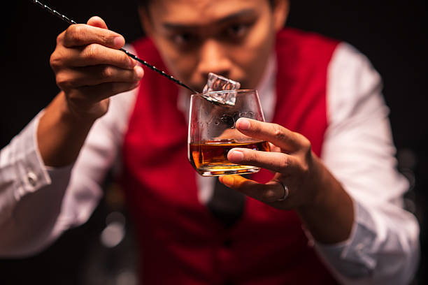 istock Bartender is pouring whiskey into a glass in a restaurant 2235858056