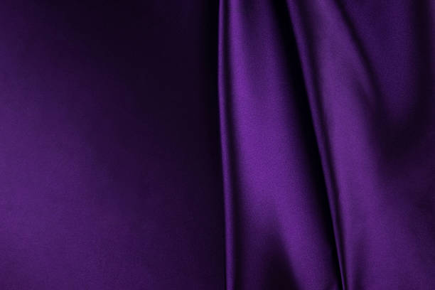 istock Purple satin background. Soft folds on shiny fabric. Luxurious backdrop with space for design. Flat lay, top view. Template. 2235858898
