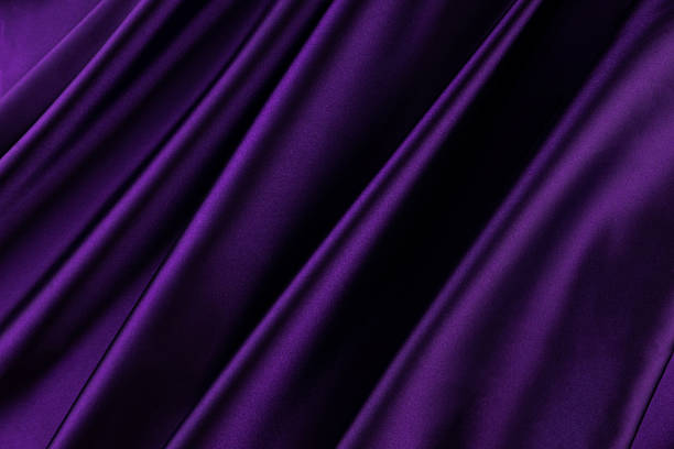 istock Purple satin background. Soft folds on shiny fabric. Luxurious backdrop with space for design. Flat lay, top view. Template. 2235858919