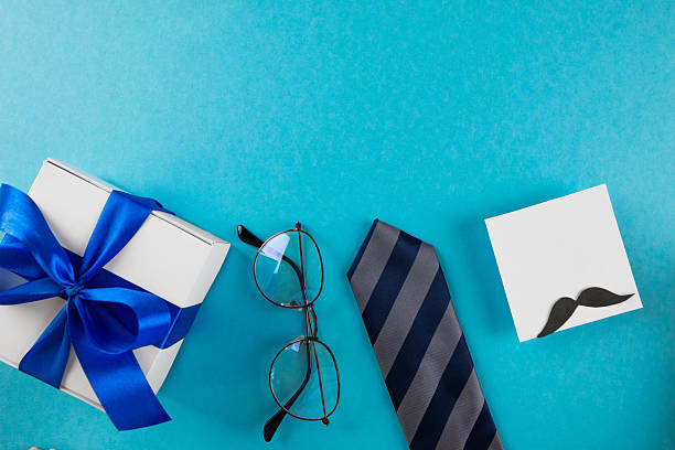 istock Accessories and decor, Father's Day greeting card, gift box and various accessories on blue background. Happy Father's Day 2235859081